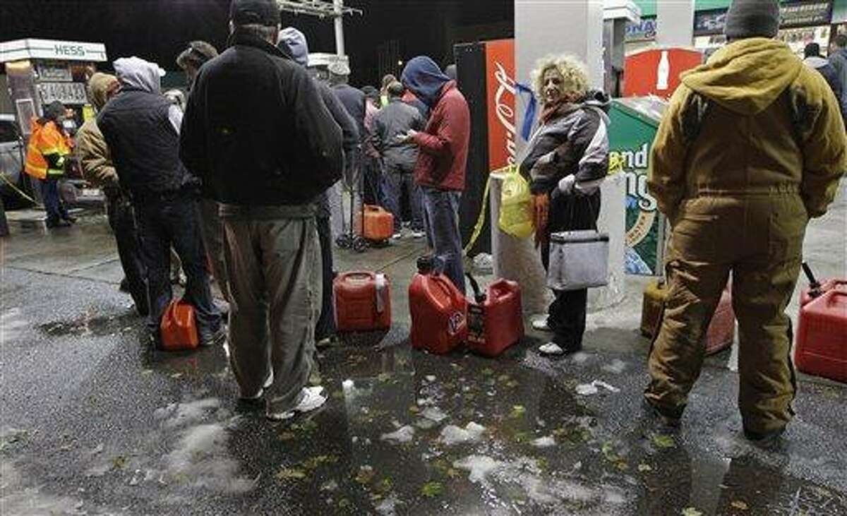 People wait in line for gasoline at a Hess station in Brooklyn Thursday where gas is still scarce in New York. Fuel shortages and distribution delays that led to gas hoarding have prompted New York City and Long Island to initiate an even-odd gas rationing plan which begins Friday at 6 a.m. in New York and 5 a.m. in Long Island. Associated Press