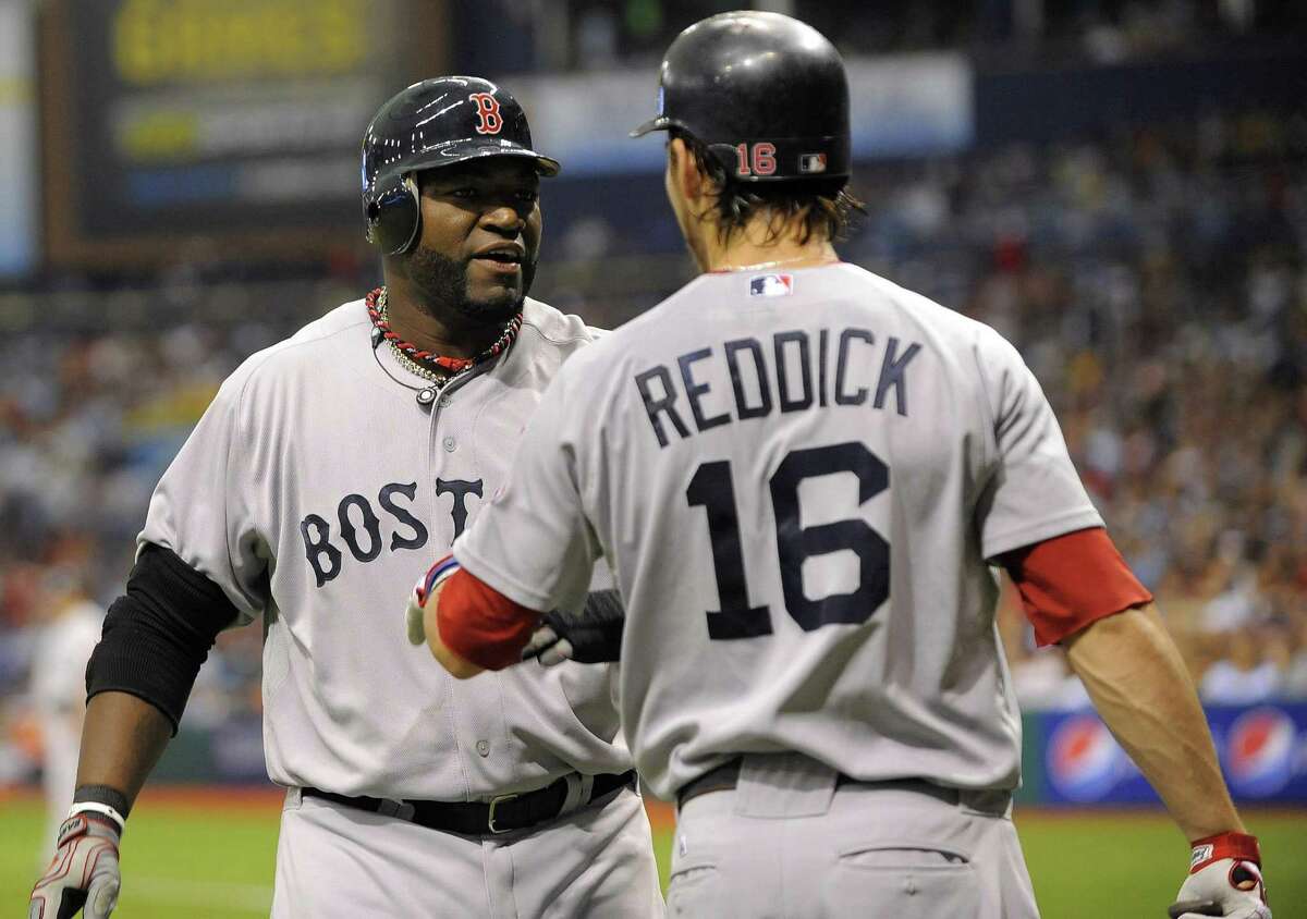 Boston Red Sox's David Ortiz, left, celebrates with teammate Josh Reddick (16) after scoring off J.D. Drew's double during the third inning of a baseball game against the Tampa Bay Rays, Saturday, July 16, 2011, in St. Petersburg, Fla. (AP Photo/Brian Blanco)