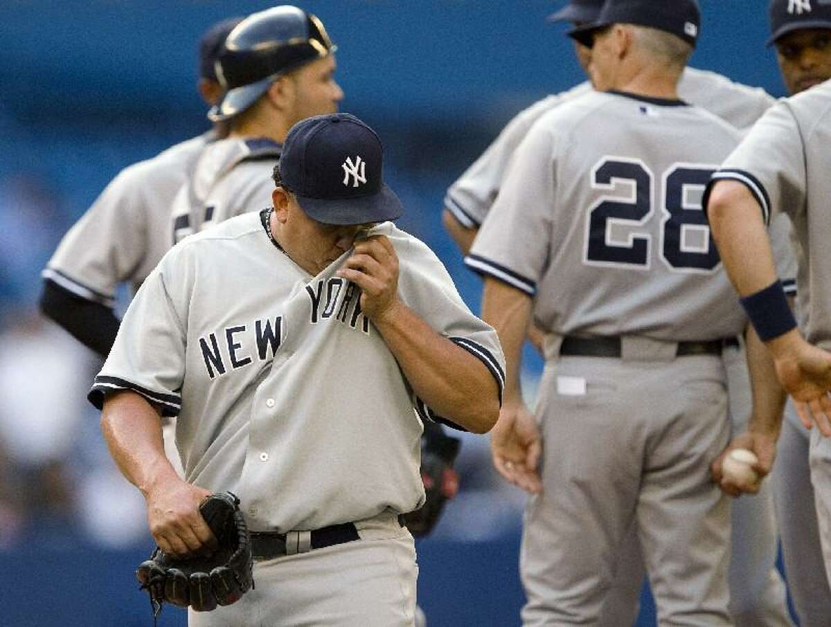 ASSOCIATED PRESS New York Yankees starting pitcher Bartolo Colon heads to the dugout after being pulled from the game against the Toronto Blue Jays during the first inning in Toronto on Thursday. The Yankees lost 16-7.