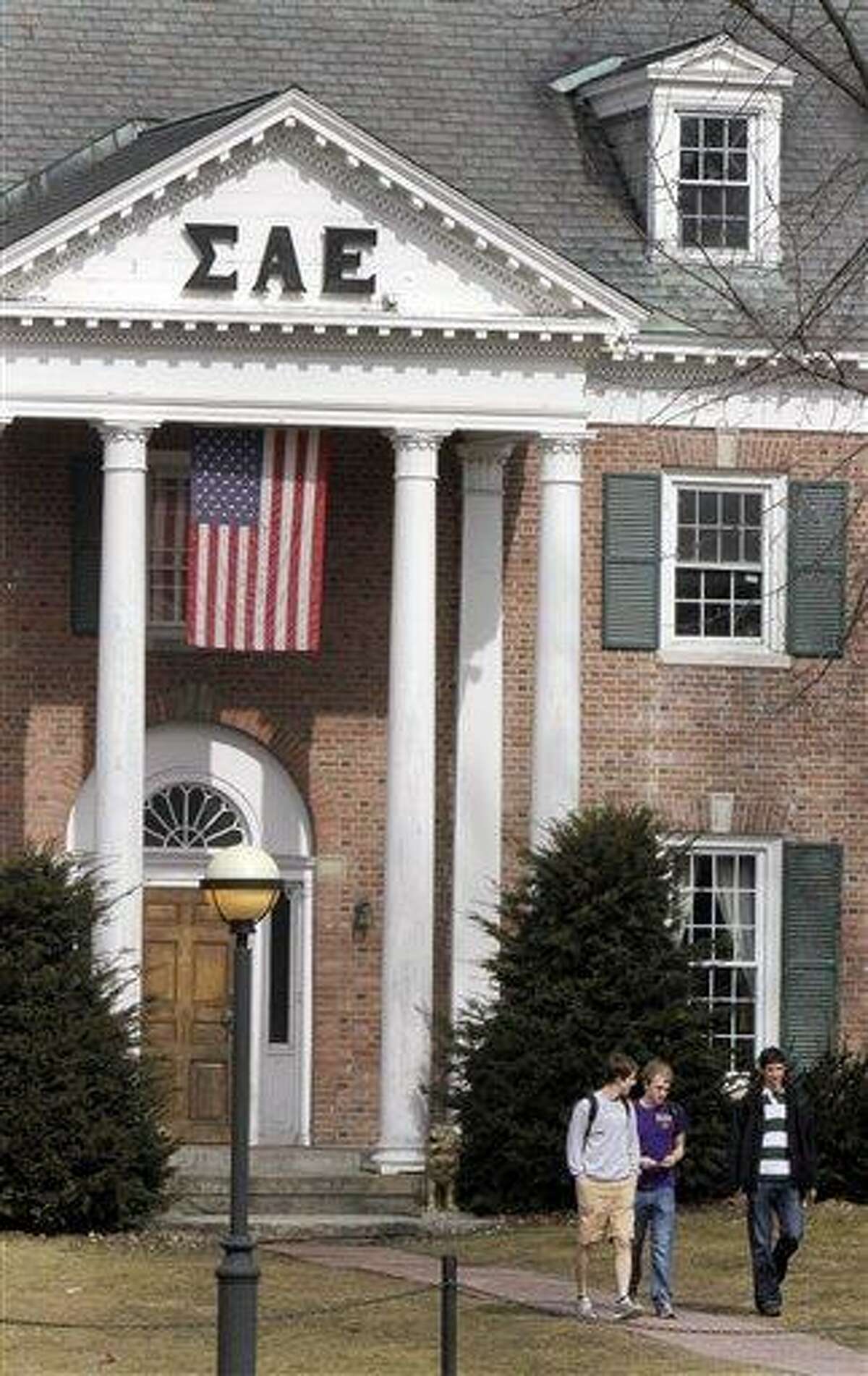 In this photo taken Monday, students leave the Sigma Alpha Epsilon fraternity on the Dartmouth College campus in Hanover, N.H. More than a quarter of the fraternity's membership has been accused by the school's judicial council of hazing after a former member alleged disgusting hazing practices. Associated Press