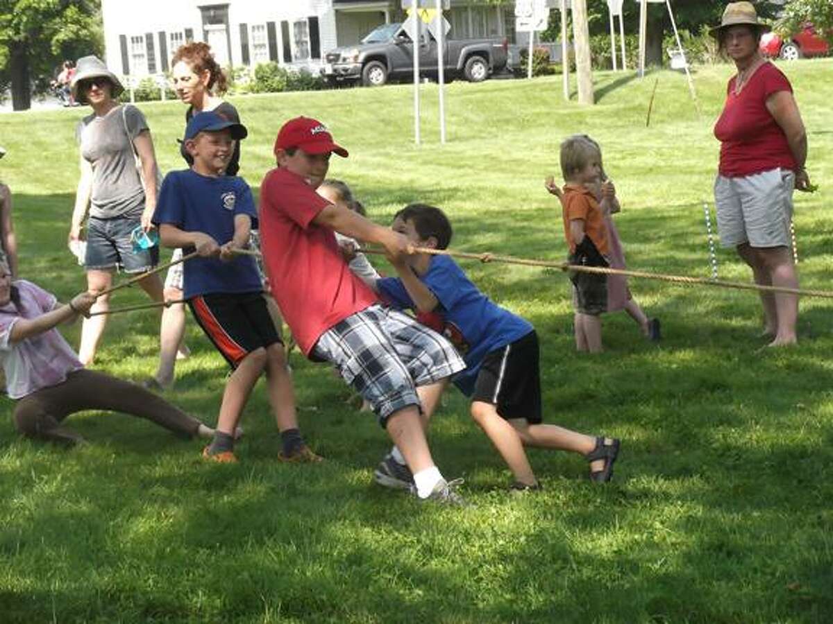 Children play tug-of-war outside the Litchfield Historical Society the same way children played it 100 years ago. (MICHELLE MERLIN / Register Citizen)