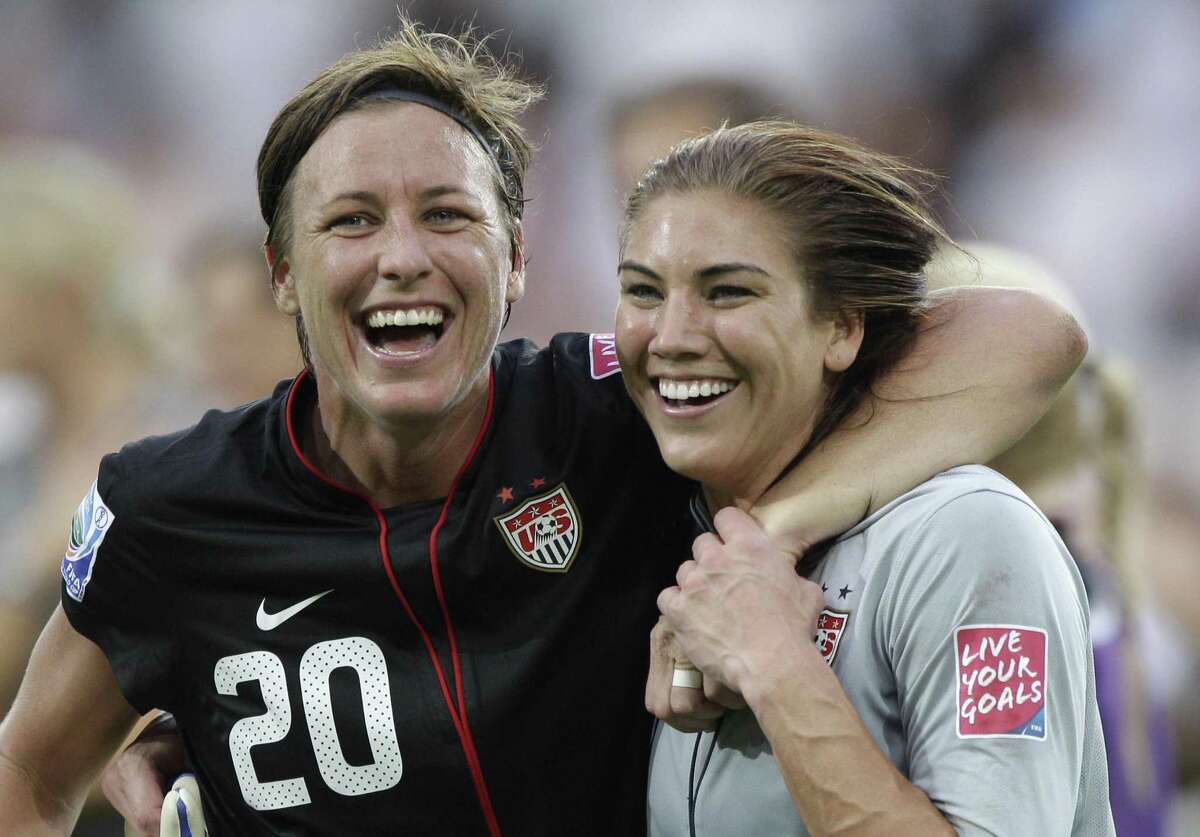 United States' Abby Wambach, left, and United States goalkeeper Hope Solo celebrate winning the the quarterfinal match between Brazil and the United States at the Women's Soccer World Cup in Dresden, Germany, Sunday, July 10, 2011. (AP Photo/Marcio Jose Sanchez)