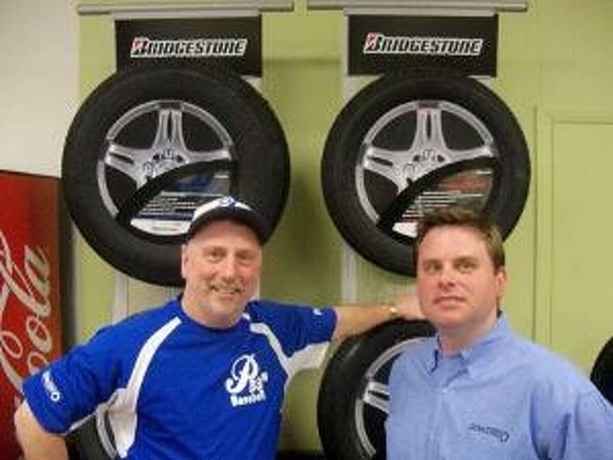 PETER WALLACE/Register Citizen Torrington P38s head coach R.J. Poniatoski and Zeller Tire owner Dave Zeller pose at Zeller Tire in Torrington Wednesday. The P38s and Zeller continued to have a strong partnership that helps both organizations.
