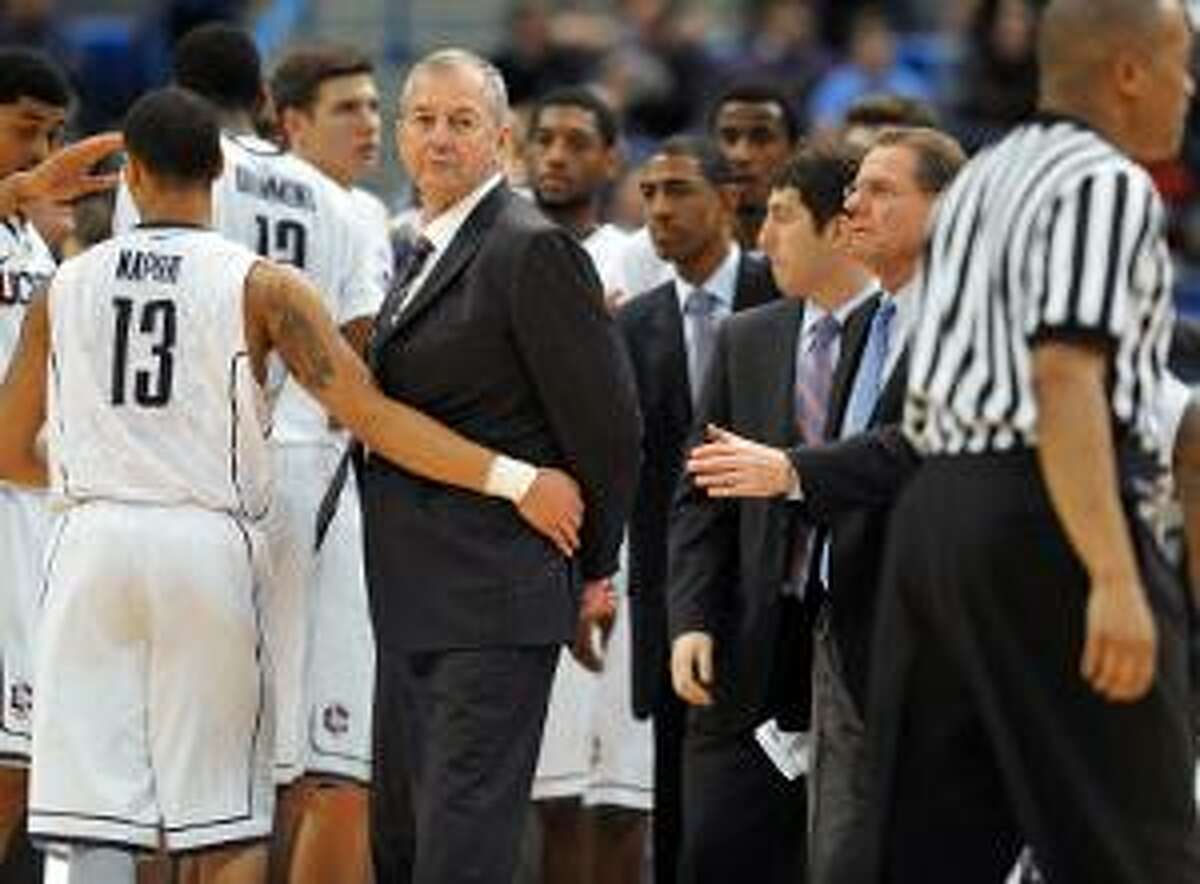 ASSOCIATED PRESS Connecticut head coach Jim Calhoun, second from left, is held back by Connecticut's Shabazz Napier (13) during a timeout in the first half of Thursday night's game against Fairfield in Hartford. The Huskies won 79-71.