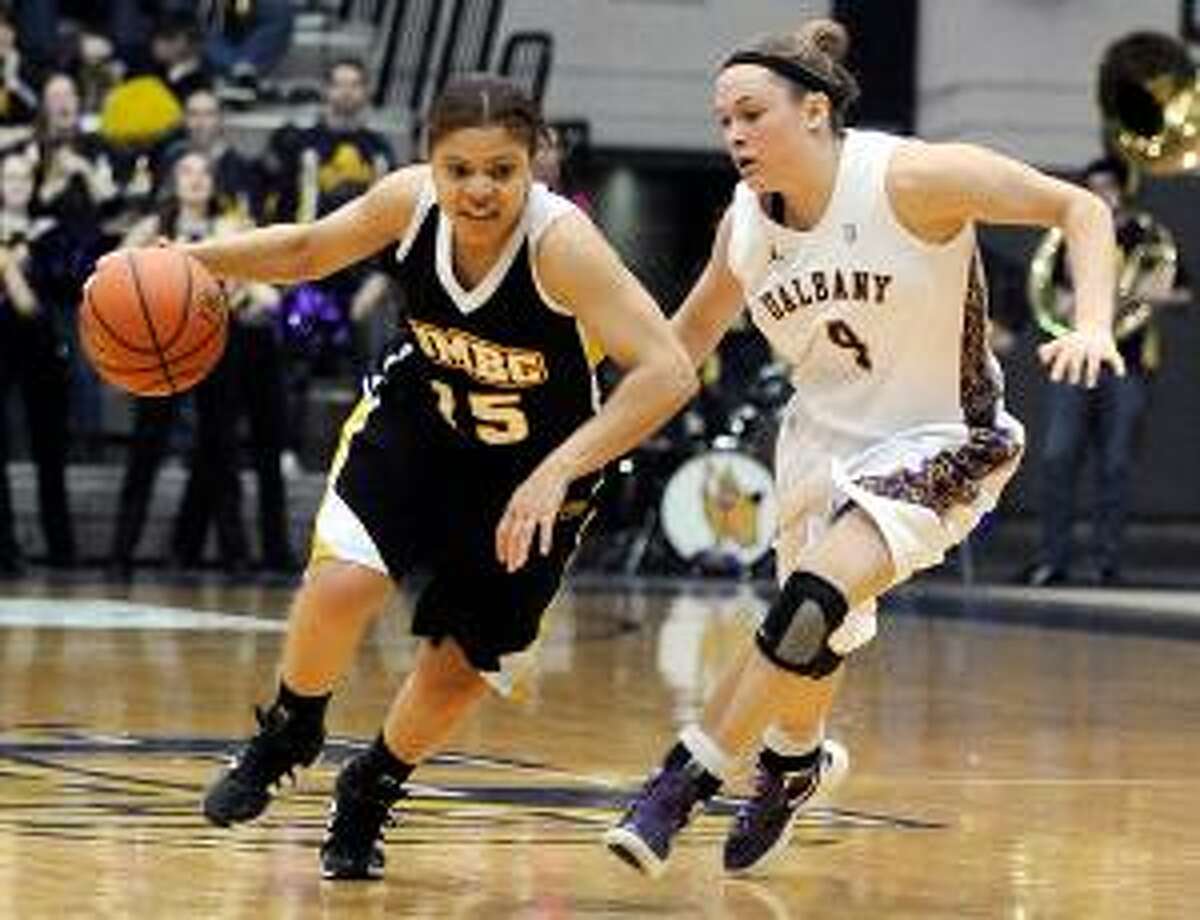 ASSOCIATED PRESS Albany's Sarah Royals (4) pressures UMBC's Raven Harris (15) during the America East Conference championship game in Albany, N.Y. The Lady Danes won 69-61 to claim their first America East title and NCAA tournament bid.