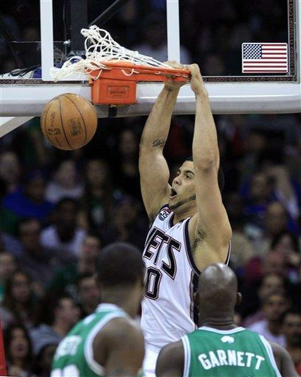 New Jersey Nets' Jordan Williams, top, dunks the ball during the second quarter of an NBA basketball game against the Boston Celtics in Newark, N.J., Saturday, April 14, 2012. (AP Photo/Mel Evans). Williams was traded Monday to the Atlanta Hawks.