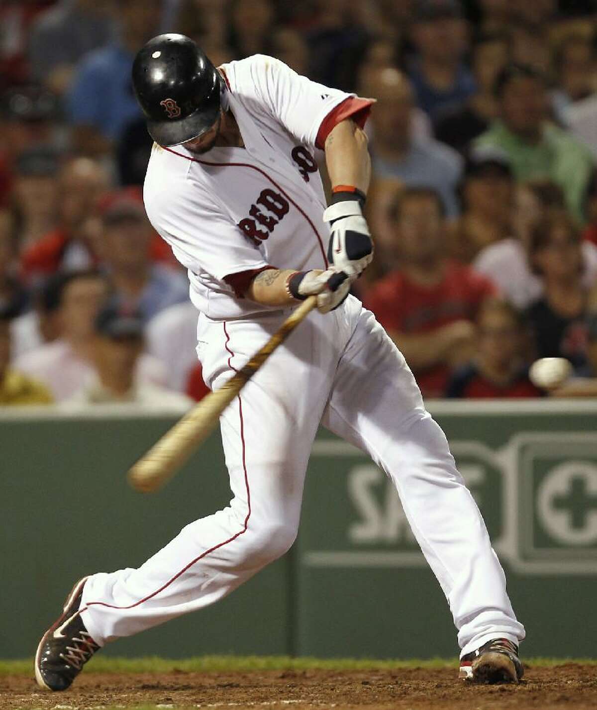 ASSOCIATED PRESS Boston Red Sox catcher Jarrod Saltalamacchia hits a home run, the third in a row for the Red Sox during the seventh inning of Thursday's game against the Baltimore Orioles at Fenway Park in Boston.