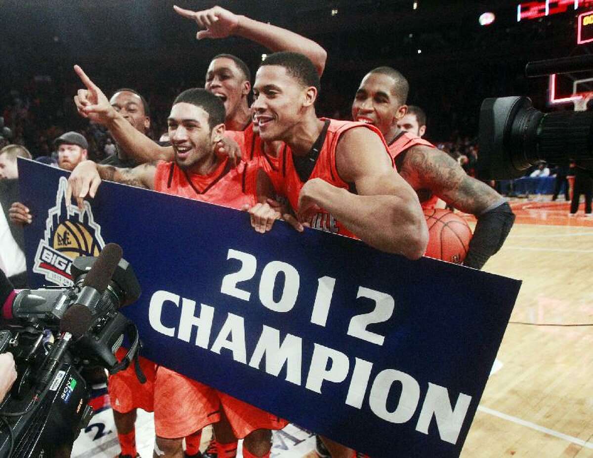 ASSOCIATED PRESS Louisville's Peyton Siva, left, celebrates with teammates after winning the Big East title against Cincinnati, 50-44 on Saturday night at Madison Square Garden in New York.