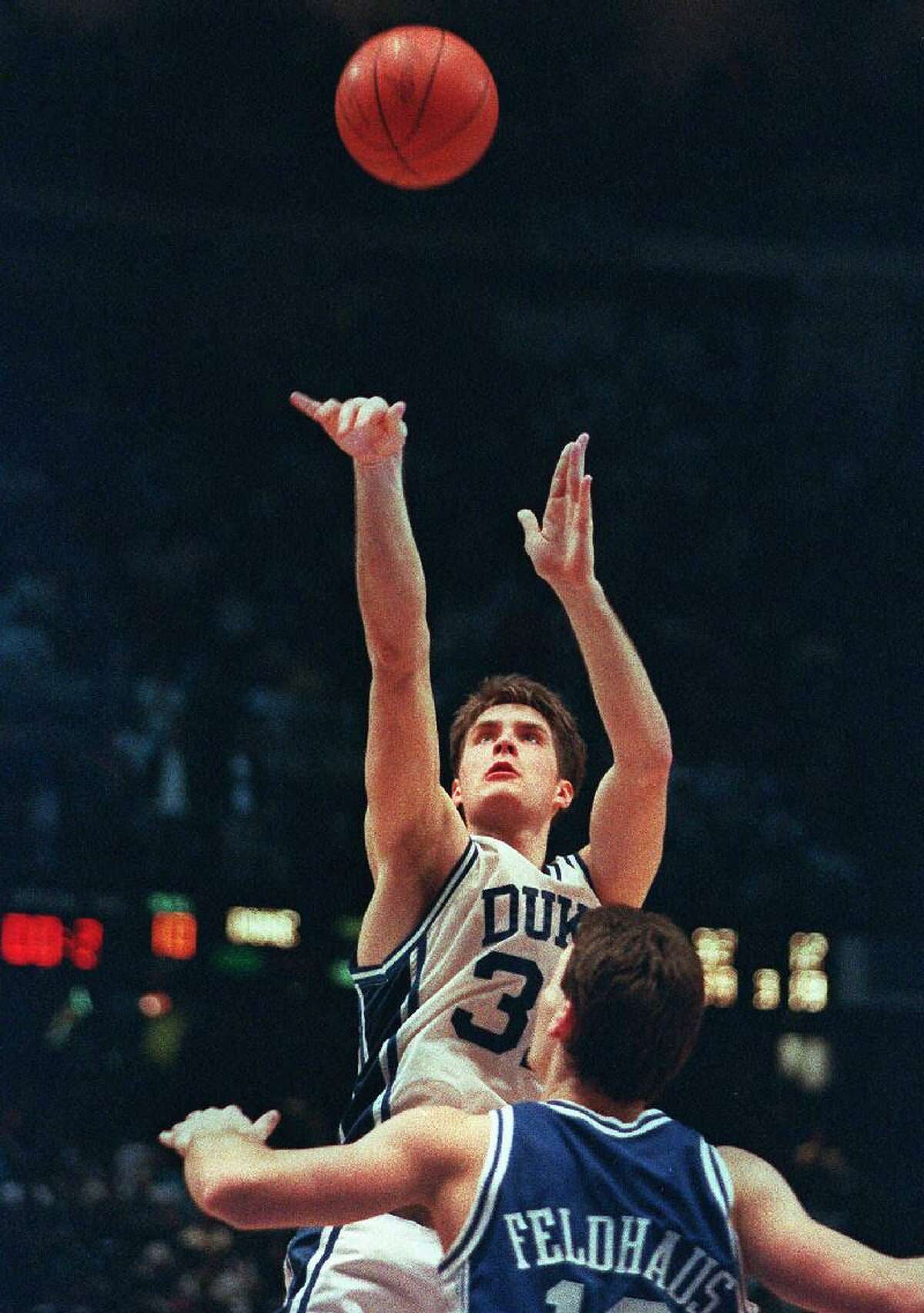 ASSOCIATED PRESS In this March 28, 1992 file photo, Duke's Christian Laettner shoots the game-winning basket in overtime over Kentucky's Deron Feldhaus to win the East Regional final in Philadelphia. Duke beat Kentucky 104-103. Laettner says it doesn't feel like it has been 20 years since his famous shot lifted Duke to victory, in part because the much-celebrated play still is replayed so often on TV. As Duke is back for another postseason run, Laettner now is far removed from that national spotlight as a new assistant coach for the NBA D-League Fort Wayne Mad Ants.