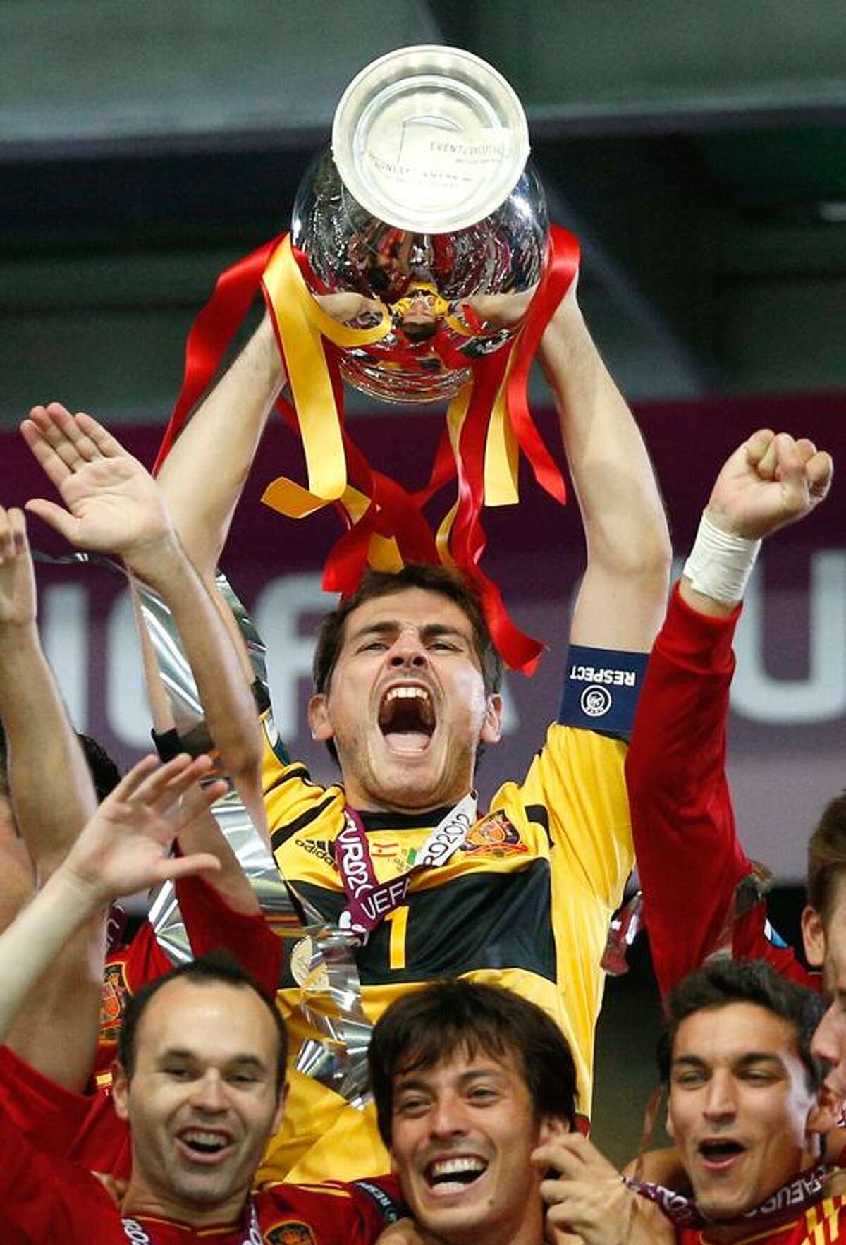 Spain goalkeeper Iker Casillas celebrate s with the trophy after the Euro 2012 soccer championship final between Spain and Italy in Kiev, Ukraine, Sunday, July 1, 2012. (AP Photo/Michael Sohn)