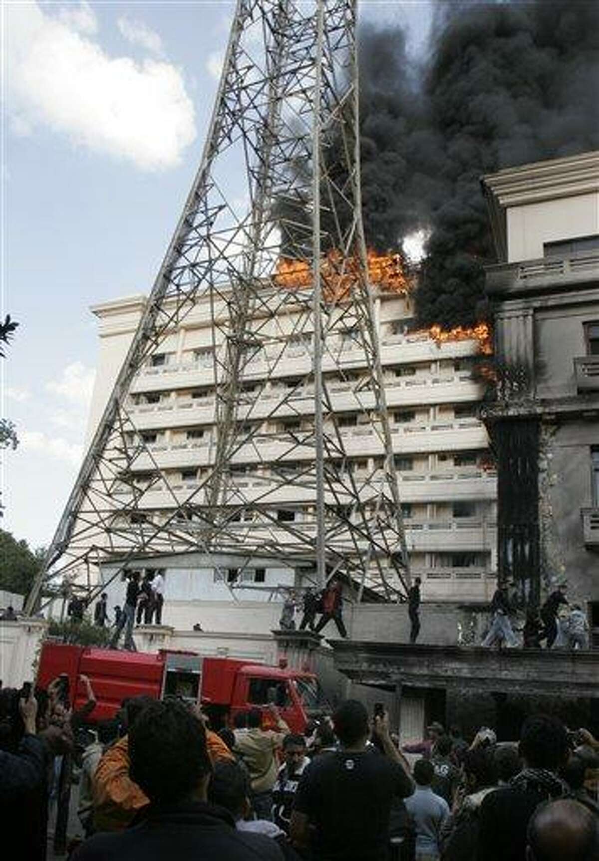Flames engulfpart of the Interior Ministry complex in Cairo, Egypt, Tuesday, March 22, 2011. An Egyptian security official says police protesting in front of Egypt's Interior Ministry have set fire to part of the downtown complex. The official says protesters lit Tuesday's fire in the building housing in the ministry's personnel department. It then spread to an adjacent building. The fire followed a protest by thousands of low-ranking police officers calling for better wages and working conditions. (AP Photo/Mohammed Abu Zaid)
