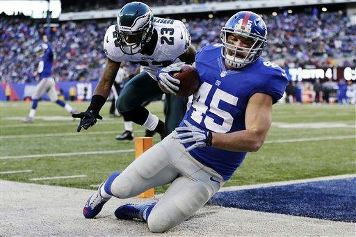 New York Giants fullback Henry Hynoski (45) catches a pass for a touchdown as Philadelphia Eagles cornerback Dominique Rodgers-Cromartie (23) defends him during the second half of an NFL football game, Sunday, Dec. 30, 2012, in East Rutherford, N.J. (AP Photo/Kathy Willens)