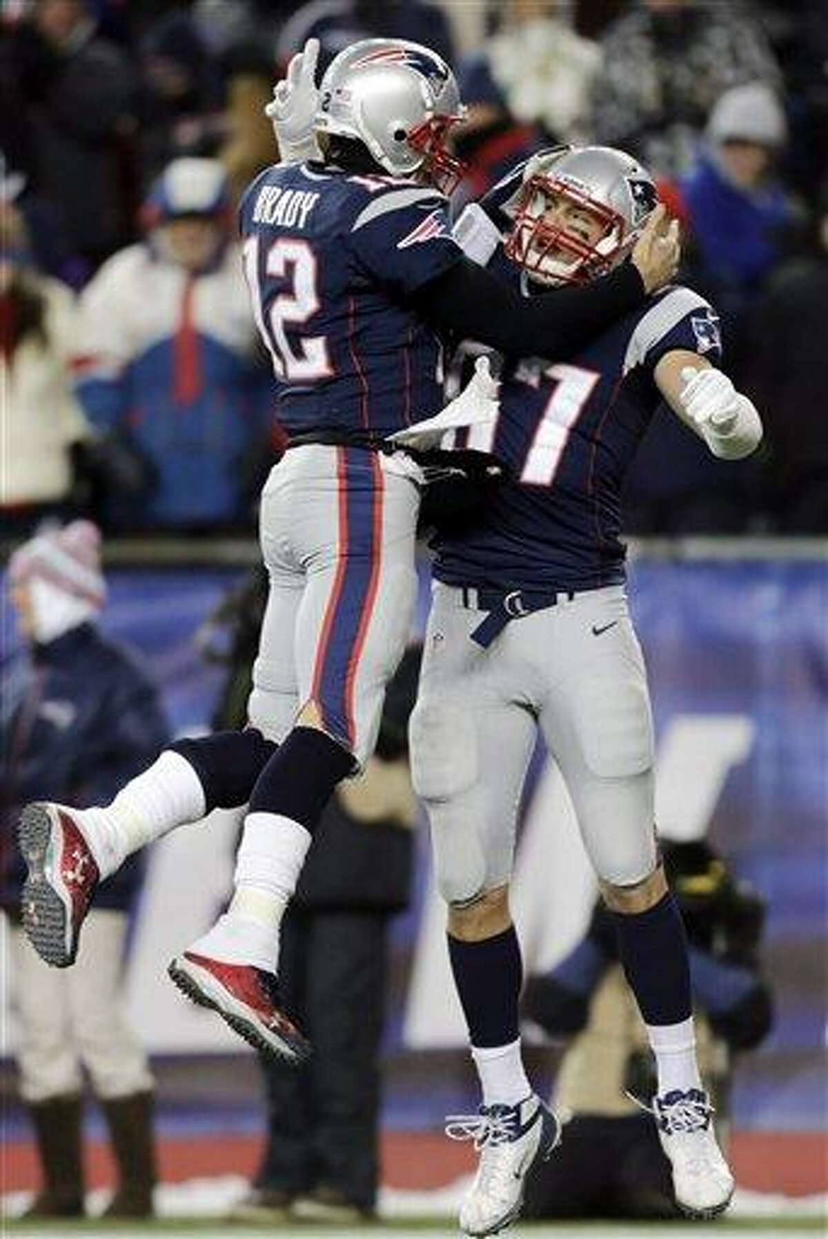 New England Patriots quarterback Tom Brady (12) celebrates his touchdown pass to tight end Rob Gronkowski (87) during the fourth quarter of an NFL football game in Foxborough, Mass., Sunday, Dec. 30, 2012. Gronkowski was active after missing five games with a broken left forearm. (AP Photo/Charles Krupa)