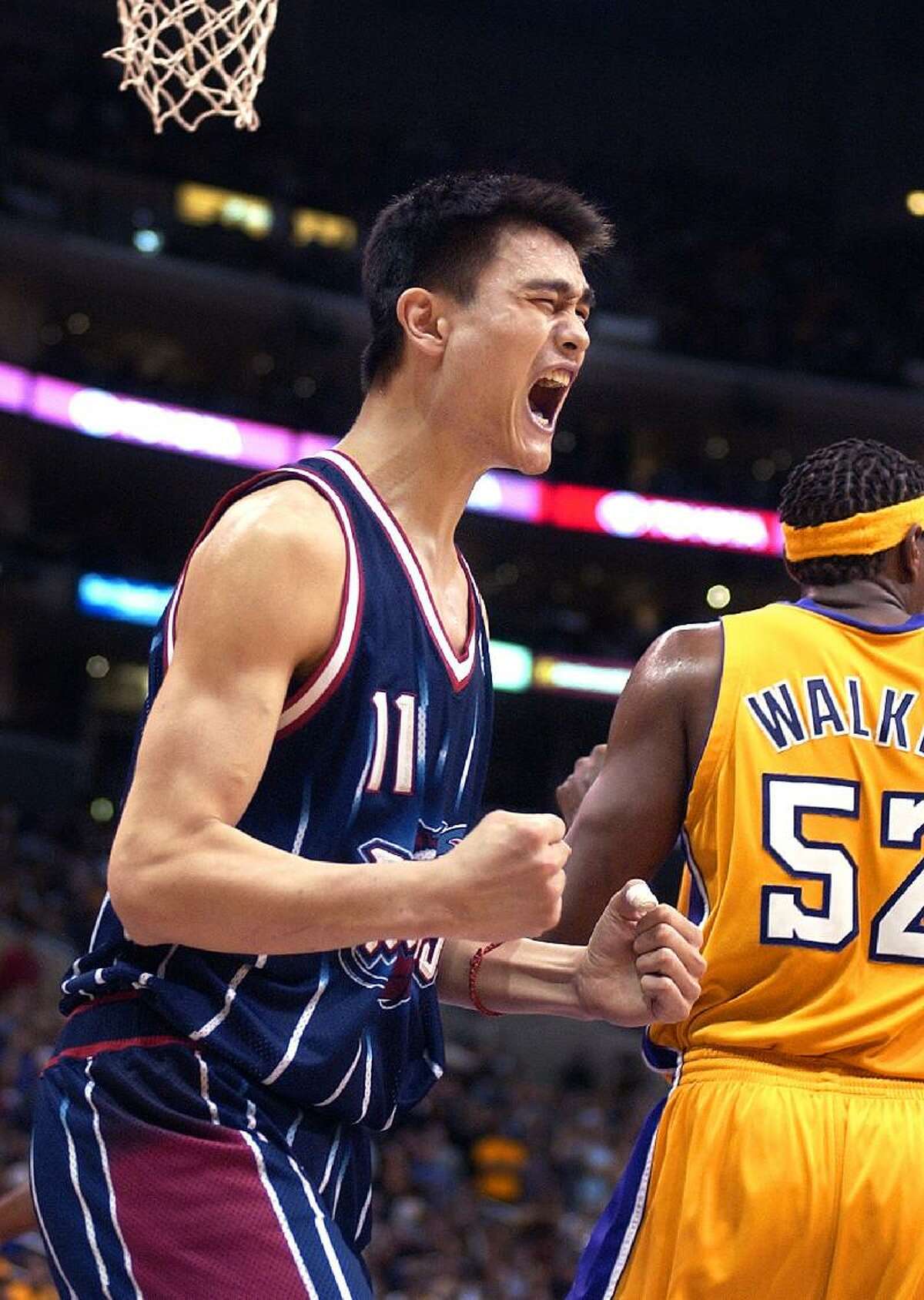 ASSOCIATED PRESS This Nov. 17, 2002 file photo shows Houston Rockets' Yao Ming reacting after scoring against the Los Angeles Lakers in Los Angeles. Yahoo! Sports is reporting that Yao Ming is retiring from basketball. The 7-foot-6 Houston Rockets center, plagued by lower-body injuries in the second half of his career, has informed the league office that his playing career is over, the website reported.