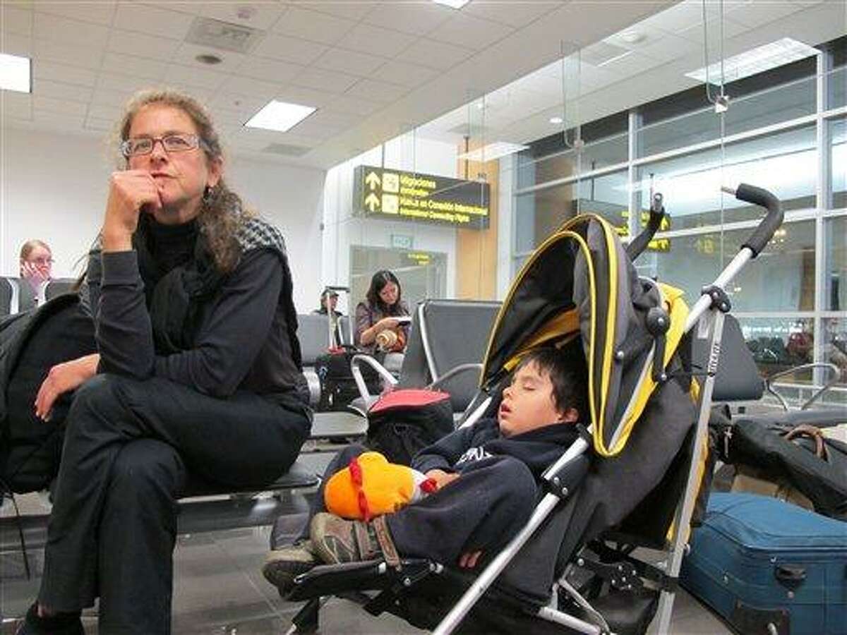 Paroled U.S. activist Lori Berenson, accompanied by her son Salvador Apari, waits at the international airport before boarding a plane to the U.S. in Lima, Peru, Monday. Associated Press