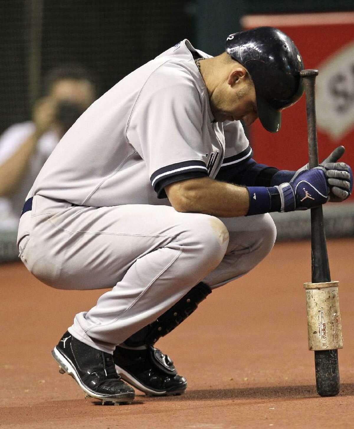 ASSOCIATED PRESS New York Yankees shortstop Derek Jeter waits to bat in the ninth inning of Wednesday's game against the Cleveland Indians in Cleveland. Jeter did not get a chance to bat in the ninth. Jeter ended the game three away from 3,000 for his career. The Indians won 5-3.