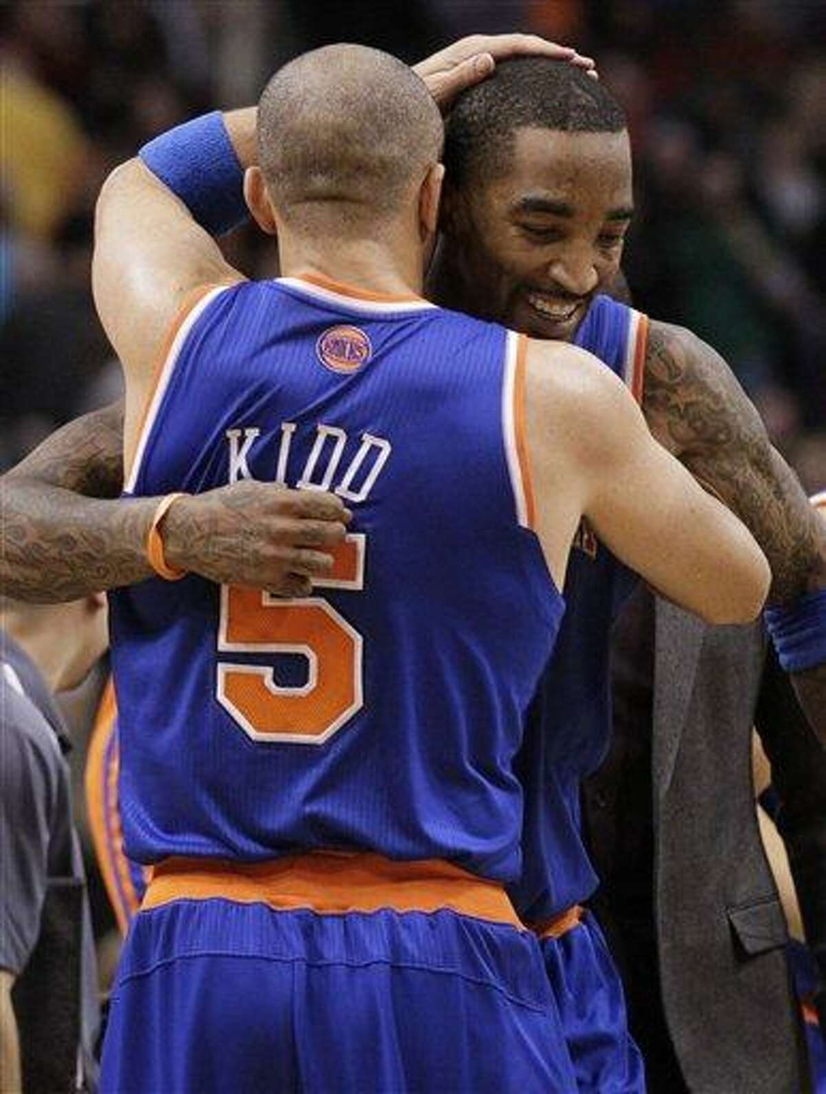 New York Knicks' Jason Kidd (5) celebrates with teammate J.R. Smith after Smith hit a game-winning basket against the Phoenix Suns during the second half of an NBA basketball game on Wednesday, Dec. 26, 2012, in Phoenix. The Knicks won 99-97. (AP Photo/Matt York)