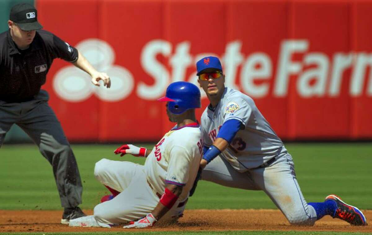 AP Photo/The Philadelphia Inquirer, Ed Hille Philadelphia Phillies' Jimmy Rollins safely slides into second for a double past New York Mets shortstop Ronny Cedeno during the third inning of Thursday's game in Philadelphia. Umpire Mike Estabrook watches at left. The Mets lost 3-2.