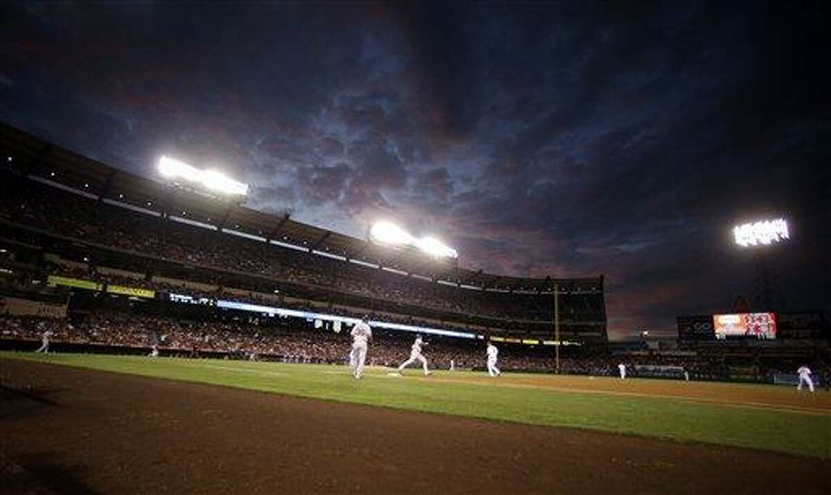 Boston Red Sox's Jarrod Saltalamacchia, center left, rounds first base after a home run against the Los Angeles Angels during the second inning of an baseball in Anaheim, Calif. Tuesday, Aug. 28, 2012. (AP Photo/Chris Carlson)