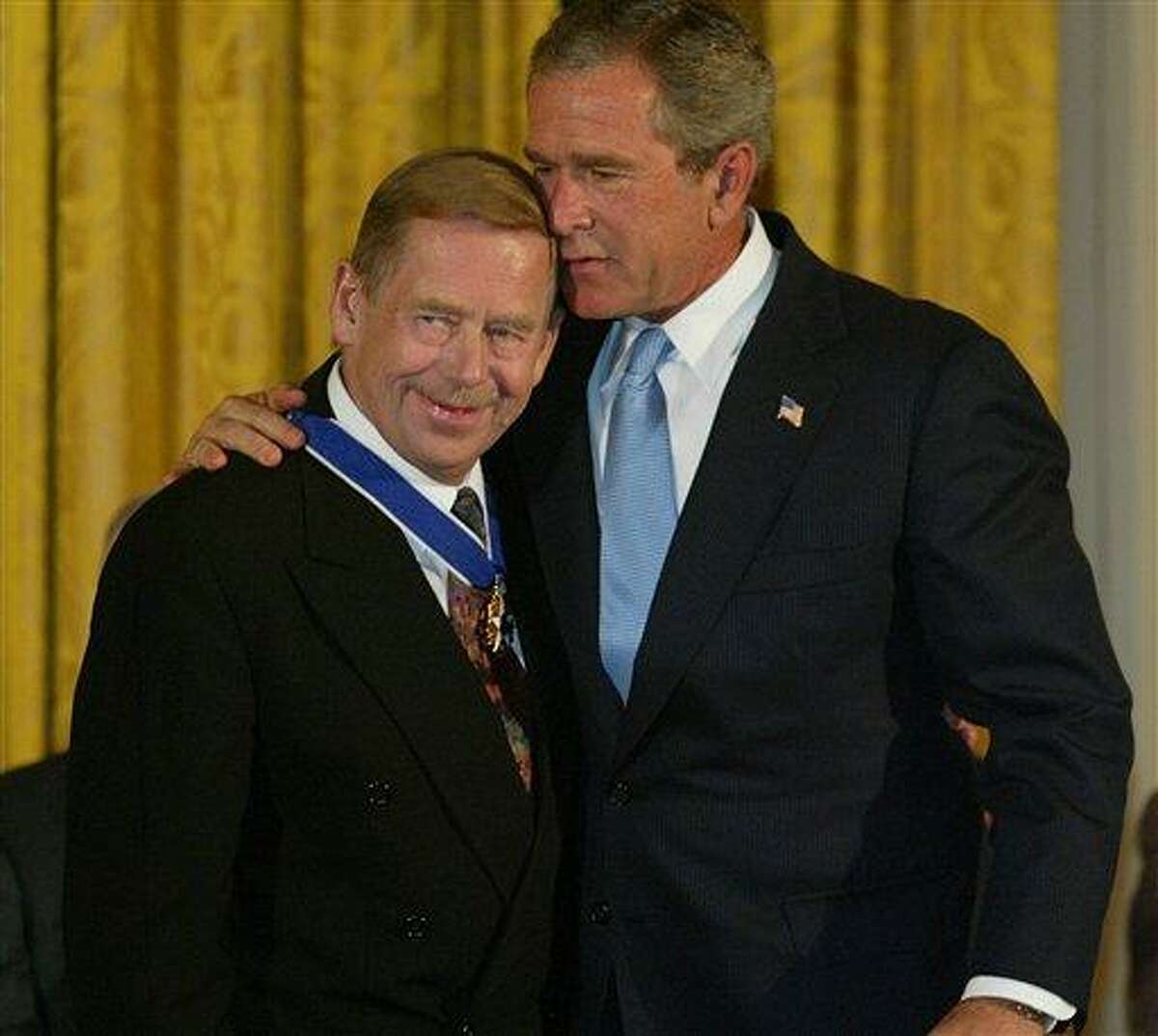 FILE - President Bush embraces Vaclav Havel, former president of the Czech Republic, after presenting him with the Presidential Medal of Freedom in the East Room of the White House in this July 23, 2003 file photo. The Presidential Medal of Freedom is the highest civilian award of the U.S. government. Havel, the dissident playwright who wove theater into politics to peacefully bring down communism in Czechoslovakia and become a hero of the epic struggle that ended the Cold War, died Sunday Dec. 18, 2011 in Prague. He was 75. (AP Photo/Charles Dharapak, File)