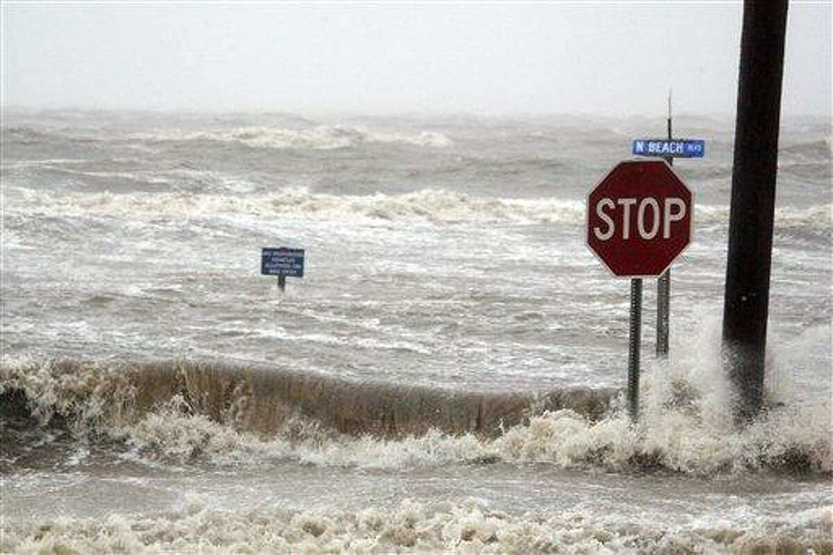 Isaac's winds and storm surge overcomes the seawall and floods Beach Boulevard in Waveland, Miss., Wednesday, Aug. 29, 2012, the seventh anniversary of Hurricane Katrina hitting the Gulf Coast. (AP Photo/Rogelio V. Solis)