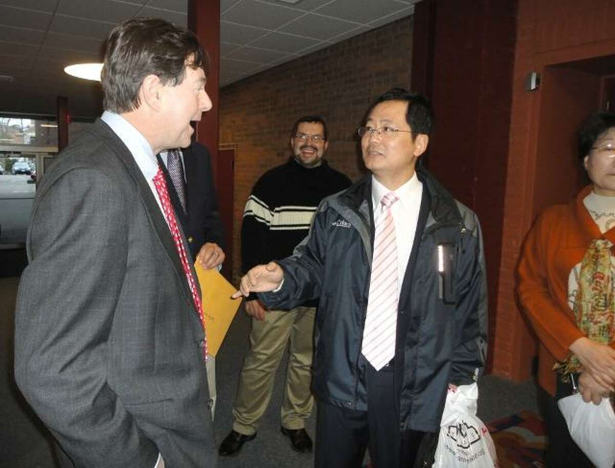 JASON SIEDZIK/Register Citizen State Sen. Andrew Roraback, left, talks with a visiting delegate from Torrington's Sister City, Changzhou, during a tour of the Warner Theatre on Friday. Behind them is the theatre's marketing director, Steve Criss.