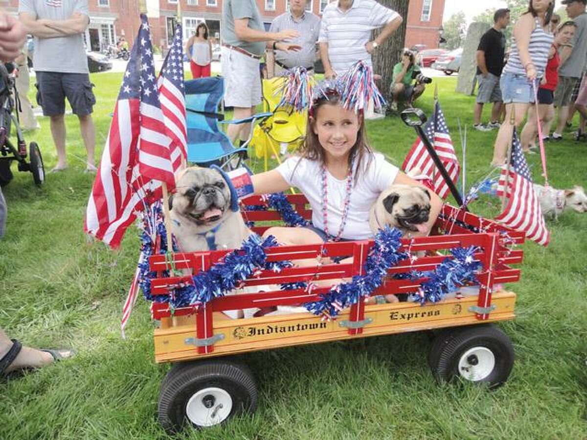JASON SIEDZIK/ Register CitizenEmma Greenwood rode in the Litchfield Historical Society Pet Parade with her pugs, Pugsley and Ella. The parade drew over 60 animals of all stripes to the Litchfield Green.