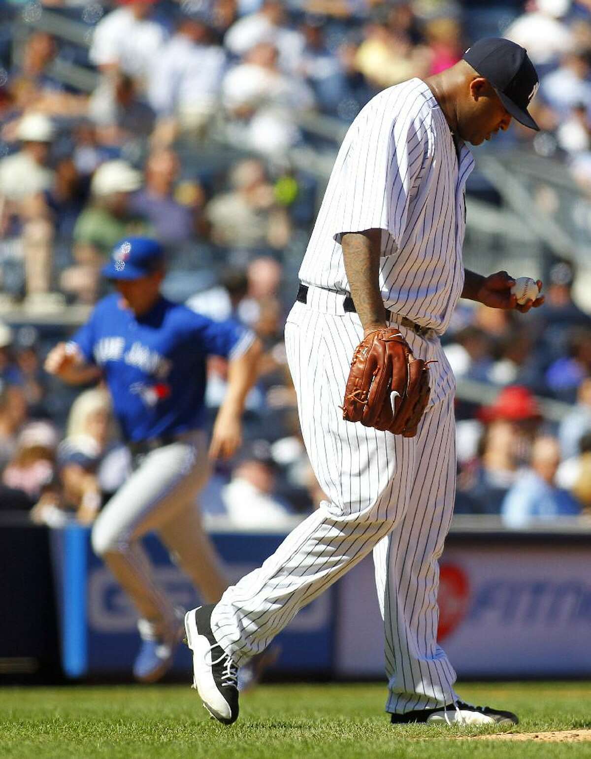 ASSOCIATED PRESS New York Yankees pitcher CC Sabathia looks down as Toronto Blue Jays' Adam Lind rounds third base on a two run-home run hit by teammate Yunel Escobar in the sixth inning of Wednesday afternoon's game at Yankee Stadium in New York. The Yankees lost 8-5.