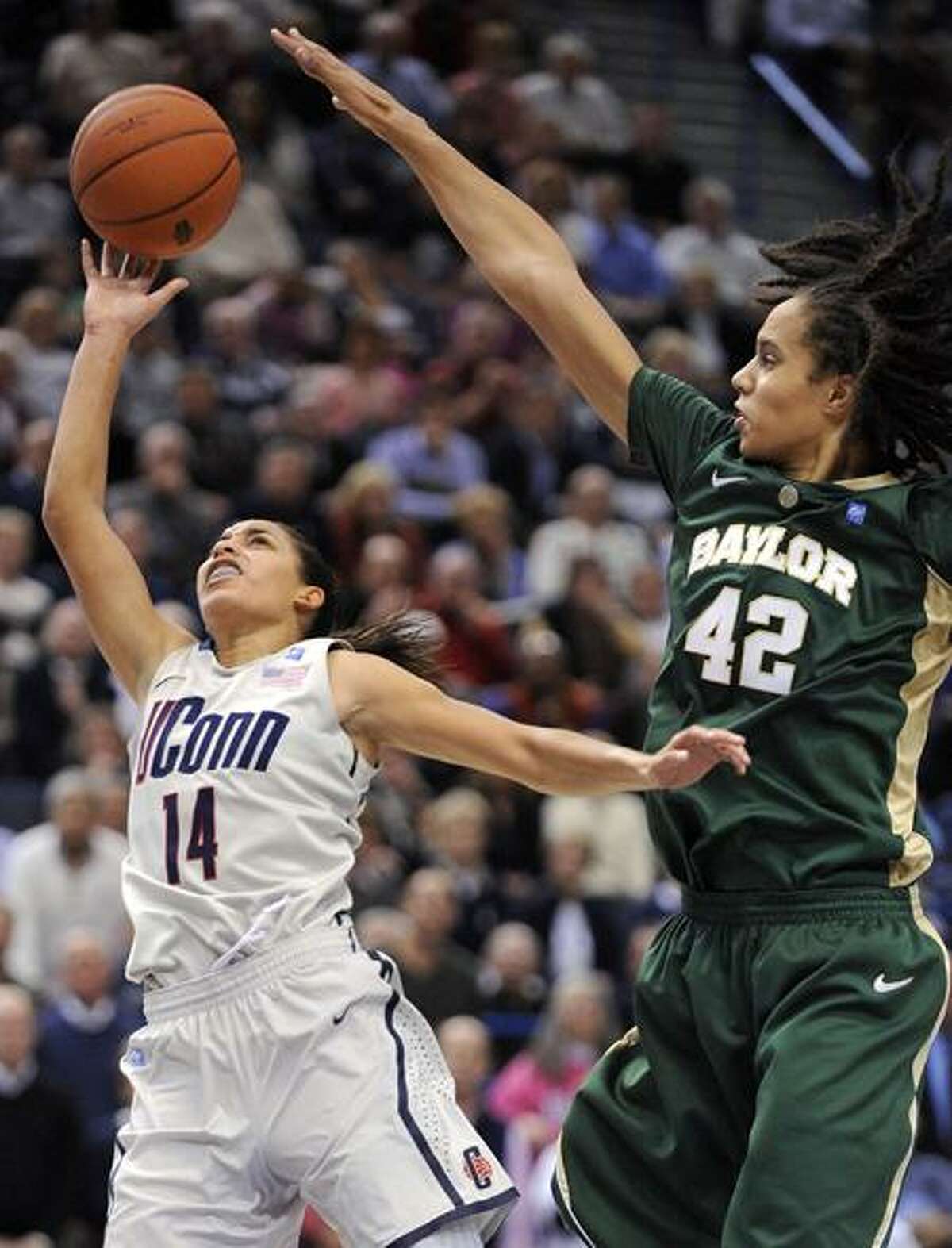 Baylor's Brittney Griner, right, defends on a shot by Connecticut's Bria Hartley during the second half of Connecticut's 65-64 victory in an NCAA college basketball game in Hartford, Conn., on Tuesday, Nov. 16, 2010. Griner scored 19 points, had seven rebounds and nine blocked shots. (AP Photo/Fred Beckham)