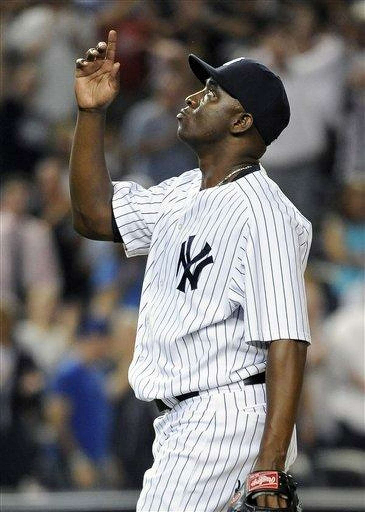 New York Yankees relief pitcher Rafael Soriano points skyward after the Yankees defeated the Toronto Blue Jays 2-1 in a baseball game on Tuesday, Aug., 28, 2012, at Yankee Stadium in New York. (AP Photo/Kathy Kmonicek)