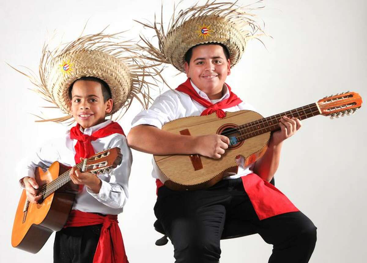 Leandro Rodriquez, 10, left, and his brother Louis Rodriguez, 12 both of West Haven, play the Cuatro. 12/21/12 December 21, 2012. Photo by Peter Hvizdak / New Haven Register.