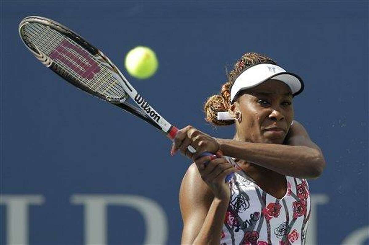 Venus Williams returns a shot to Bethanie Mattek-Sands in the first round of play at the 2012 US Open tennis tournament, Tuesday, Aug. 28, 2012, in New York. (AP Photo/Kathy Willens)