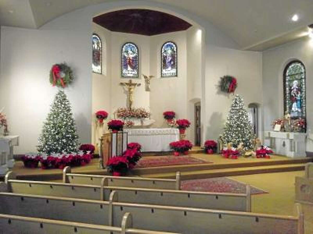 St. Maron's Church in Torrington decorated its altar with poinsetta plants with the names of the 27 victims, who were killed in the Sandy Hook Elementary School shooting on Dec. 14, on angels as rememberance and part of the church's annual Christmas decorations. "We have to remember that these beautiful victims are gifts," said Father Larry Michael.
