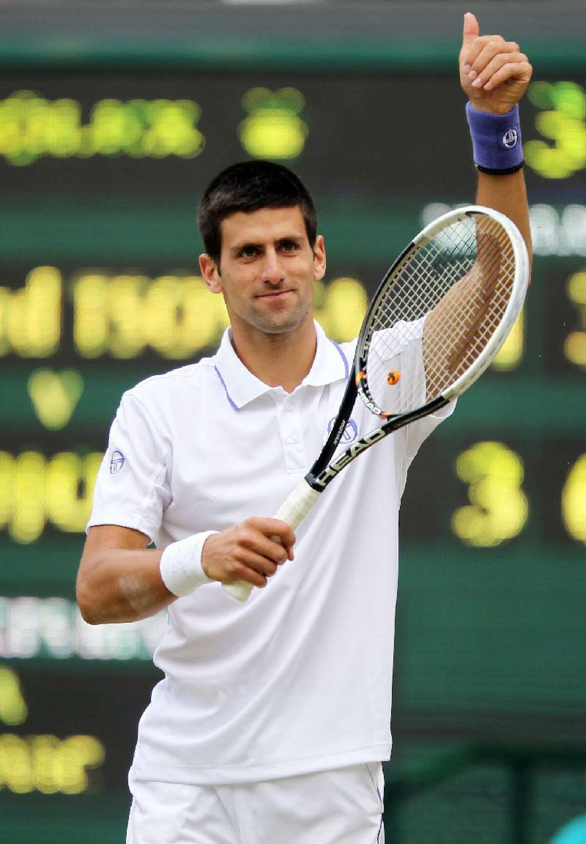 ASSOCIATED PRESS Serbia's Novak Djokovic celebrates defeating France's Jo Wilfried Tsonga on Friday at the 2011 Wimbledon Championships at the All England Lawn Tennis and Croquet Club.