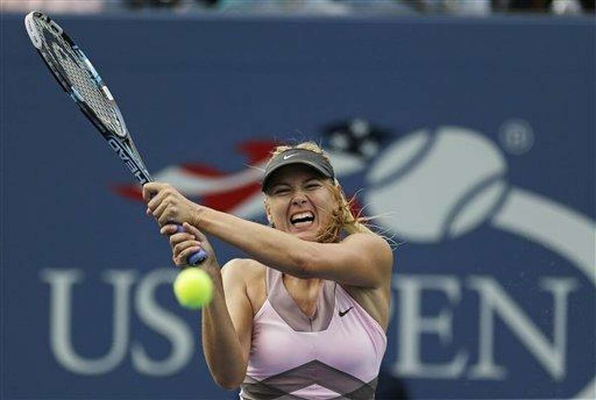 Maria Sharapova, of Russia, returns a shot to Melinda Czink, of Hungary, at the 2012 US Open Tennis tournament, Monday, Aug. 27, 2012, in New York. (AP Photo/Mike Groll)