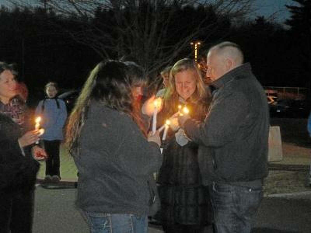 JASON SIEDZIK/ Register Citizen Residents of Harwinton and Burlington grieved together at Lewis S. Mills High School as the two towns held a joint vigil in memory of the victims of the Dec. 14 Sandy Hook Elementary School shooting.