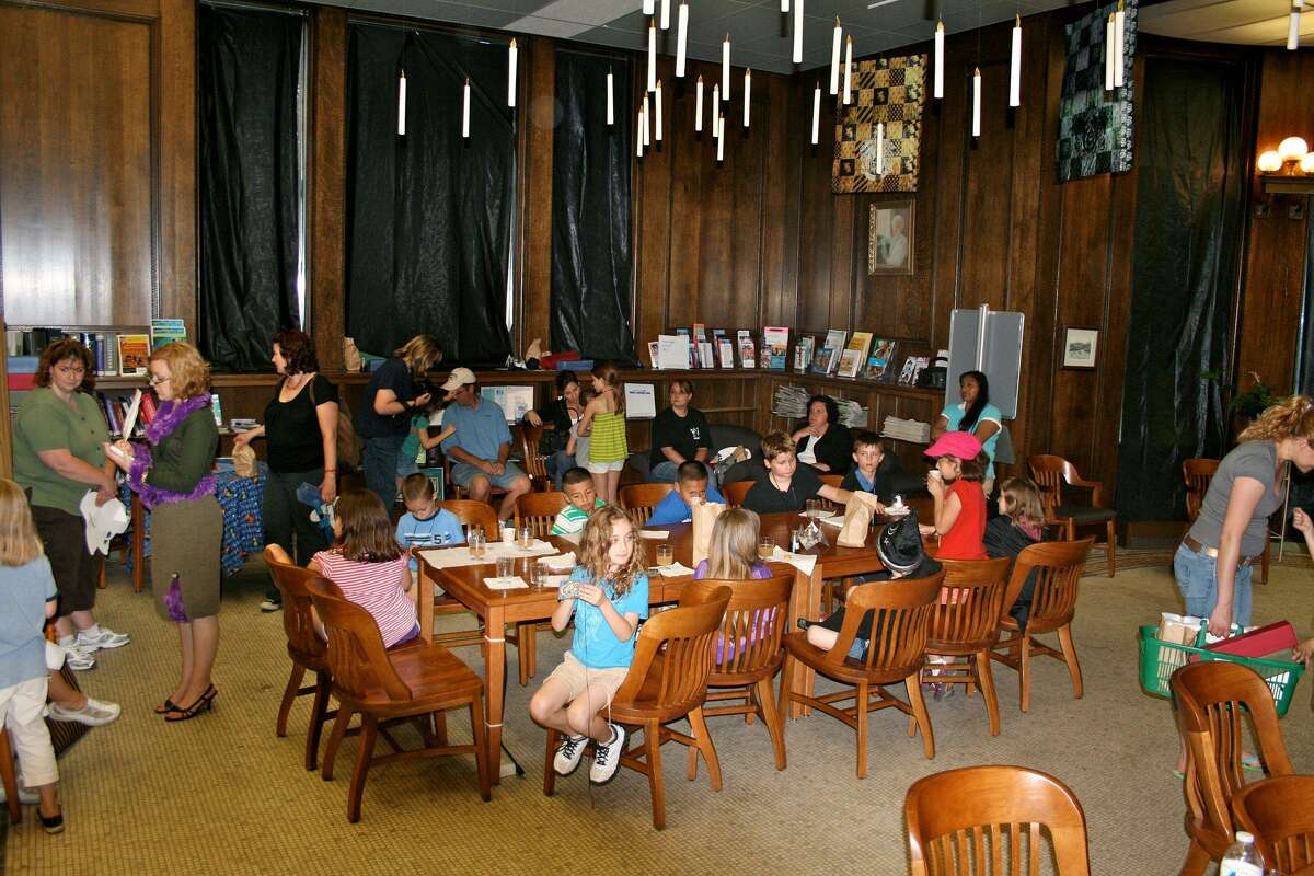 Children gather in the Great Hall, complete with floating candles, during the Harry Potter celebration at the Torrington Library.