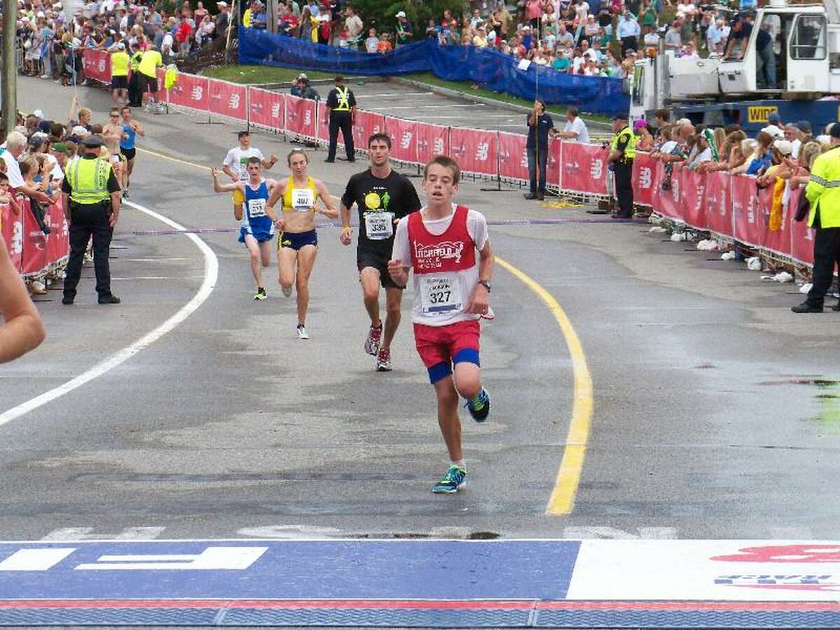 DAVE DRISCOLL/Submitted photo Harwinton 15-year-old Jackson Morrow, seen here about to cross the finish line at the Falmouth Road Race on Aug. 12, was one of many area runners who put in plenty of work over the summer.