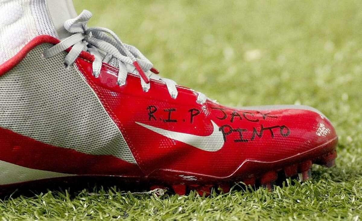 The shoe of New York Giants wide receiver Victor Cruz bears the words "R.I.P. Jack Pinto" in memory of one of the children killed in the Sandy Hook Elementary School shootings in Newtown, Connecticut, during first half NFL play against the Atlanta Falcons, in Atlanta, Georgia, December 16, 2012. REUTERS/Tami Chappell