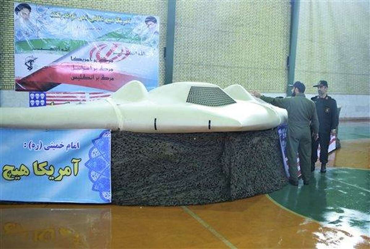 This photo, released on Thursday by the Iranian Revolutionary Guards, claims to show a US RQ-170 Sentinel drone which Tehran says its forced down. The chief of the aerospace division of Iran's Revolutionary Guards, Gen. Amir Ali Hajizadeh, right, listens to an unidentified colonel, in an undisclosed location in Iran. Associated Press