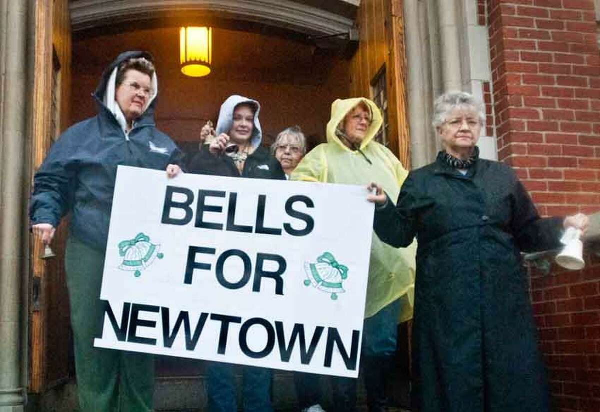DERBY_ Left to right: Arlene Jachyra, Allyson Satkowski, Fran Tracz, Sandy Mendyk, and Sandie Jemioto ring bells for the victims af Sandy Hook. The church bell at St. Michael's had not been working. Melanie Stengel/Register