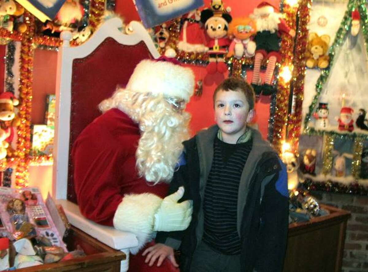 DEBBI MORELLO/ Register Citizen William Goodwin, 7, visited with Santa at Christmas Village on Sunday. This was the 64th year the magical village opened for children of all ages.