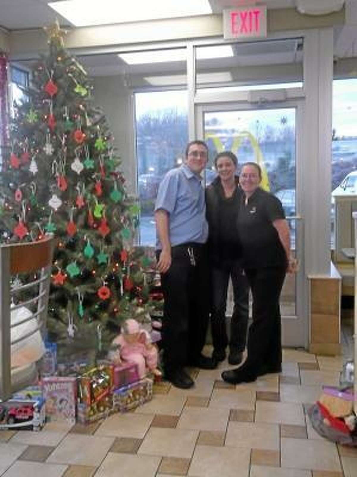 NIKKI TRELEAVEN/The Register Citizen East Main Street McDonald's in Torrington raised more than $3,000 to buy more than 300 toys that will be distributed to four local charities: Susan B. Anthony Project, Torrington Chapter of FISH, Torrington Fire Department and the State Police Department Toy's for Tots drive. Department Manager Robbi Licina and McDonald's employee Mary Mastrobuono with state Police Officers Greg Zordan, left, and Mike Burke.