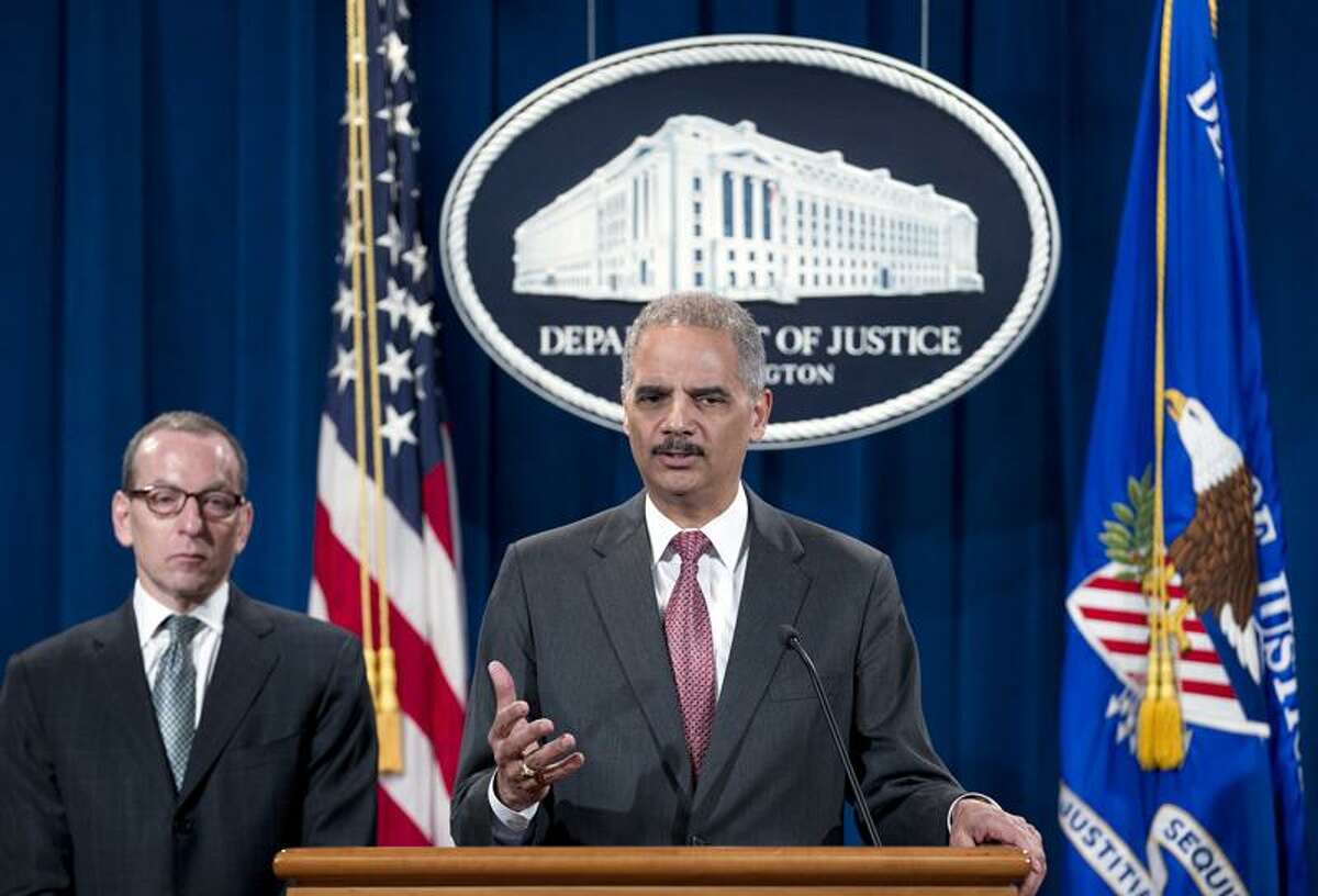 Attorney General Eric Holder speaks during a news conference at the Justice Department in Washington, Wednesday, Dec. 19, 2012, during an announcement that the international investment bank UBS Securities Japan Co. Ltd., will pay more than $1.5 billion in penalties in three nations to resolve charges of trying to manipulate an interest rate used as a benchmark in global banking transactions. Holder says UBS Securities Japan Co. Ltd., will plead guilty to felony wire fraud and admit to attempting to manipulate the London Interbank Offered Rate. Two former UBS senior traders will be charged with conspiracy, including one also charged with wire fraud in New York federal court. (AP Photo/Jose Luis Magana)