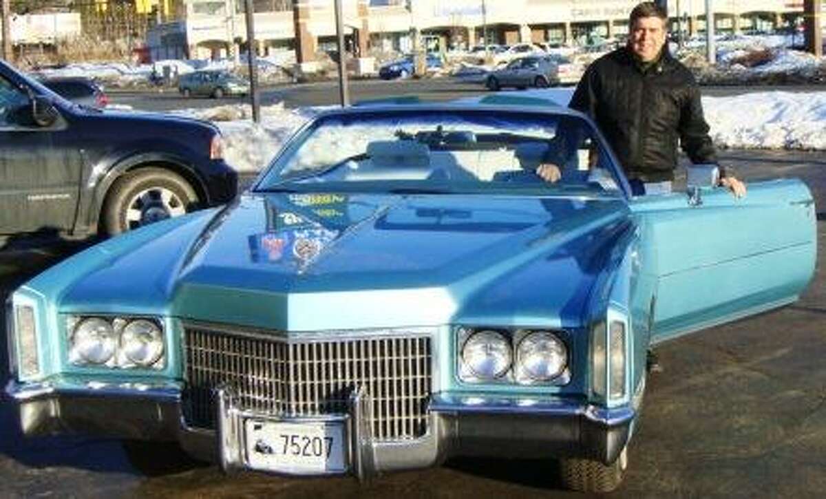 Tim Chapulis, owner of Tim's Inc., with a mint-condition Cadillac that will be included in the annual Cabin Fever Auction on March 27 in Bristol. Admission fees to the event are donated to St. Jude's Children's Research Hospital.