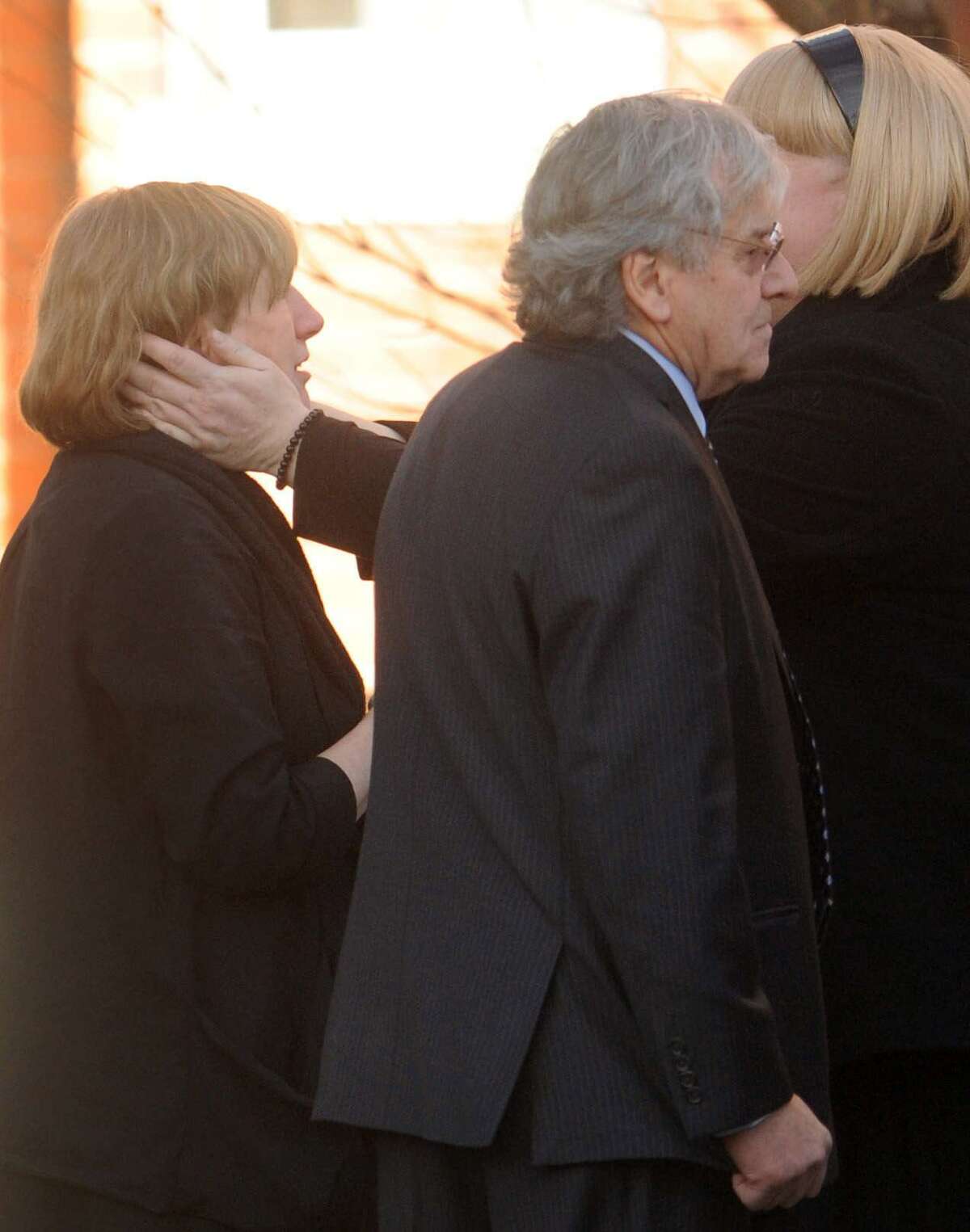 Teresa Rousseau, left, is comforted with conversation by a mourner, as Gilles Rousseau, second from left, waits with his ex-wife after a memorial service for their daughter Lauren Rousseau at the First Congregational Church in Danbury, Conn. Thursday, December 20, 2012. Rousseau was a substitute teacher killed by a gunman that also claimed the lives of 5 other educators and 20 children at the Sandy Hook Elementary School shooting Friday, December 15, 2012. Lauren and Gilles Rousseau are divorced. Photo by Peter Hvizdak / New Haven Register