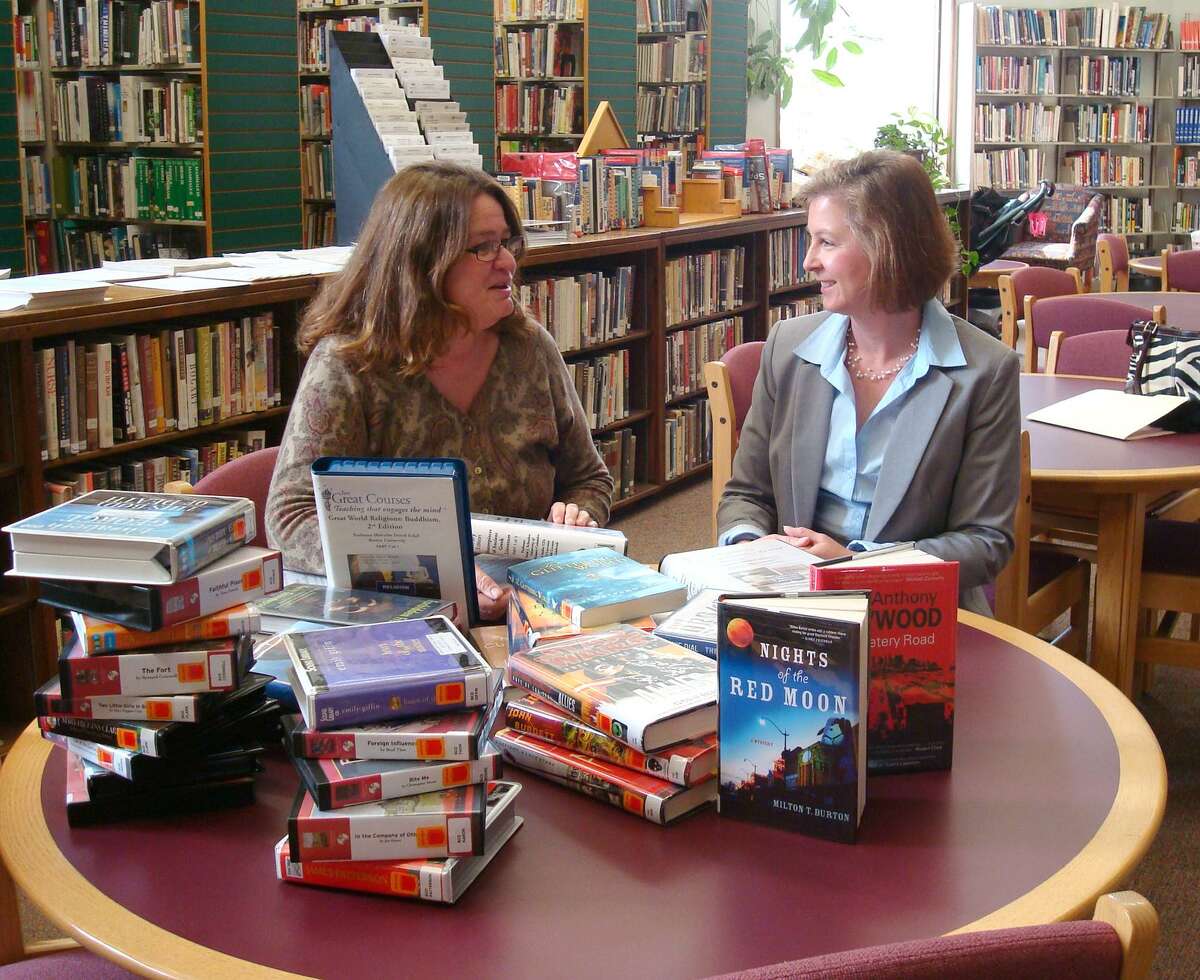 Submitted photo Debra Radosevich, Director of Thomaston Public Library discusses the new books and courses with Dawn Nielsen, Marketing Manager of Thomaston Savings Bank.