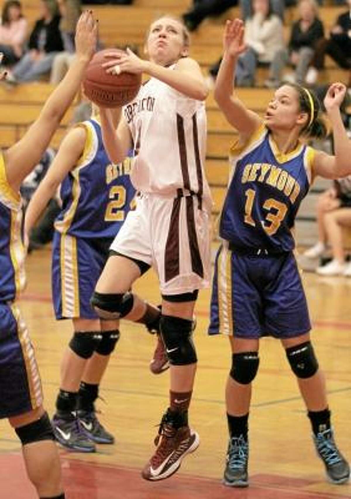 Nicole Kozlak of the Lady Raiders goes to the hoop as Seymour's Aleesha Johnson (13) tries to block. Photo by Marianne Killakey/Special to Register Citizen