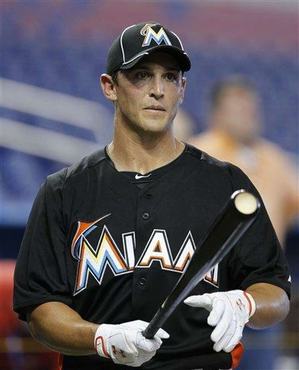 Adam Greenberg prepares for batting practice before a baseball game against the New York Mets in Miami, Tuesday, Oct. 2, 2012. The Miami Marlins signed the former Chicago Cubs prospect to a one-day contract effective Oct. 2, and play him that day against the New York Mets. (AP Photo/Alan Diaz)