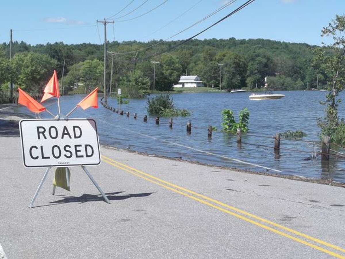 RICKY CAMPBELL/ Register Citizen North Shore Road in Litchfield was closed to through traffic Monday following Bantam Lake's overflow onto the road. Tropical storm Irene flooded many parts of the region and brought with it a loss of power to Litchfield for most of Sunday and Monday.